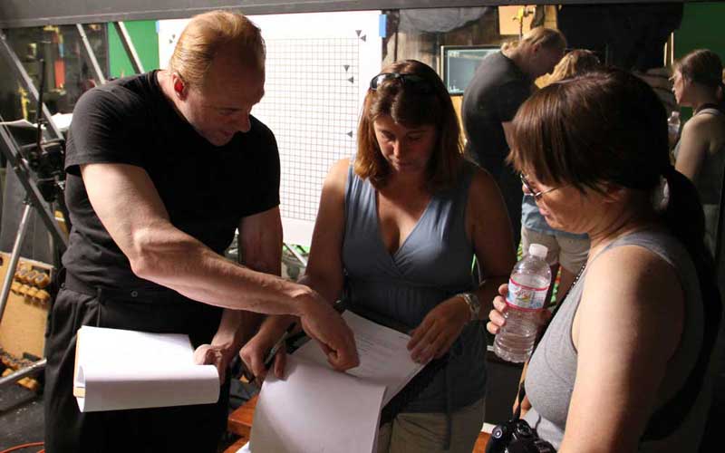 Director Trygve Lode, Assistant Director Nancy Snyder and Producer Darlene Cypser go over the script.