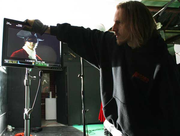 Jon Firestone adjusting the monitor with Macleish Day as The Highwayman on the screen