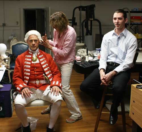 Macleish Day chats with director Trygve Lode while Lorraine Altamura touches up Trygve's wig.